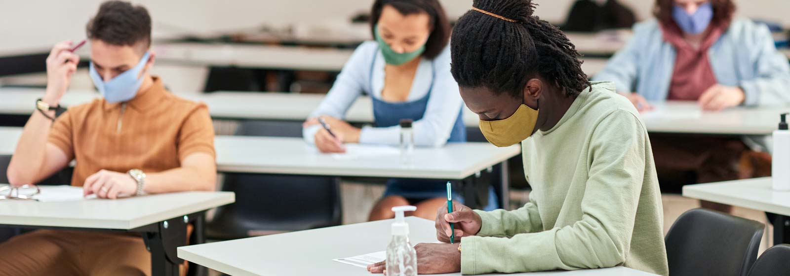 Students sitting at desks writing