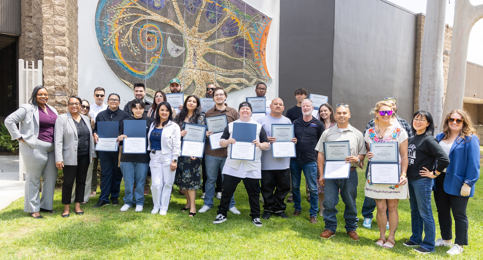 Apprenticeship program students holding their certificates