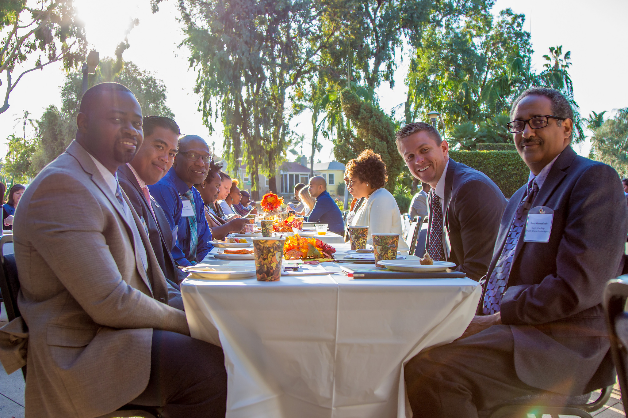 members of clergy and local community leaders sit outside ECC for community breakfast
