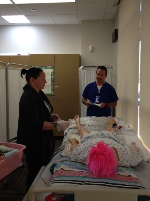 faculty and student working hands on in health careers classroom