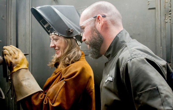 Brad Dorschel, Master Welder and SDCE faculty member instructs Andrea Cook, SDCE student during Shielded Metal Arc Welding project