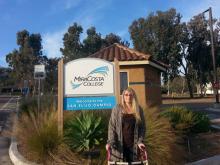 student Kimber Thurman in front of Mira Costa campus sign