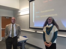 two people in classroom; facing camera