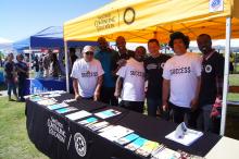 Students and instructors staffing outreach booth